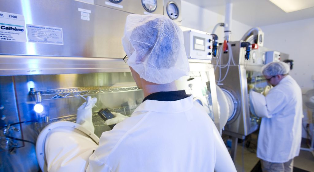 Nelson Employees performing a product sterility isolator test